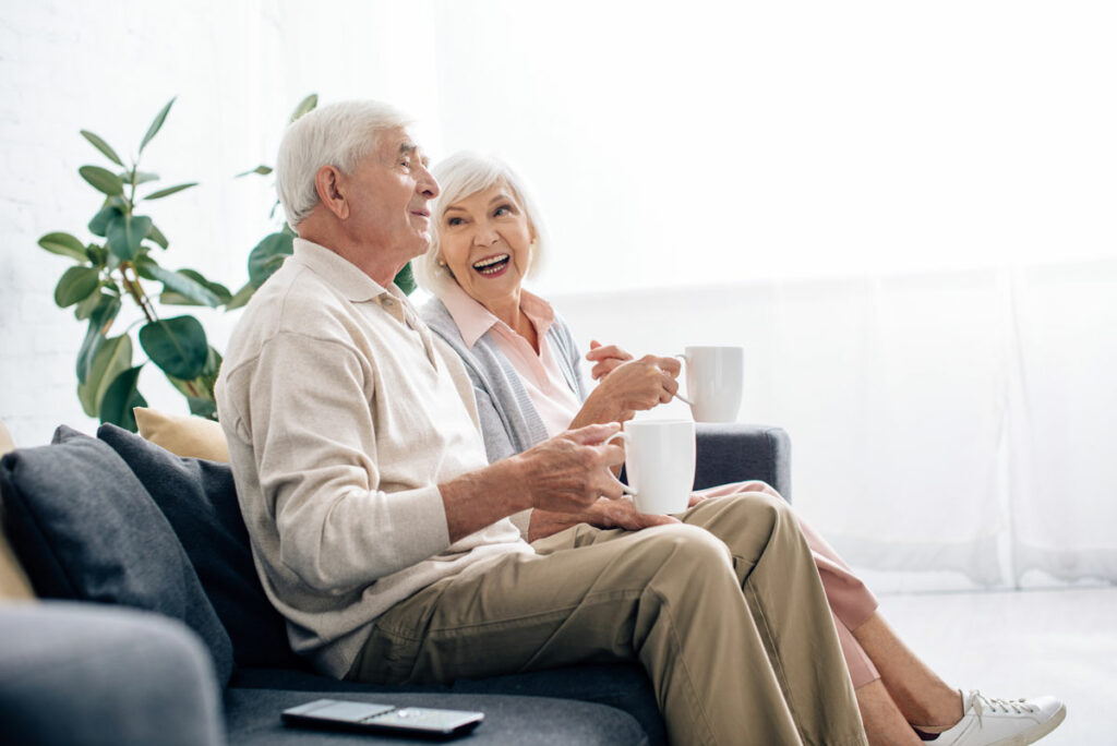 Sage Oak of Denton | Innovative senior living - senior couple sitting on couch