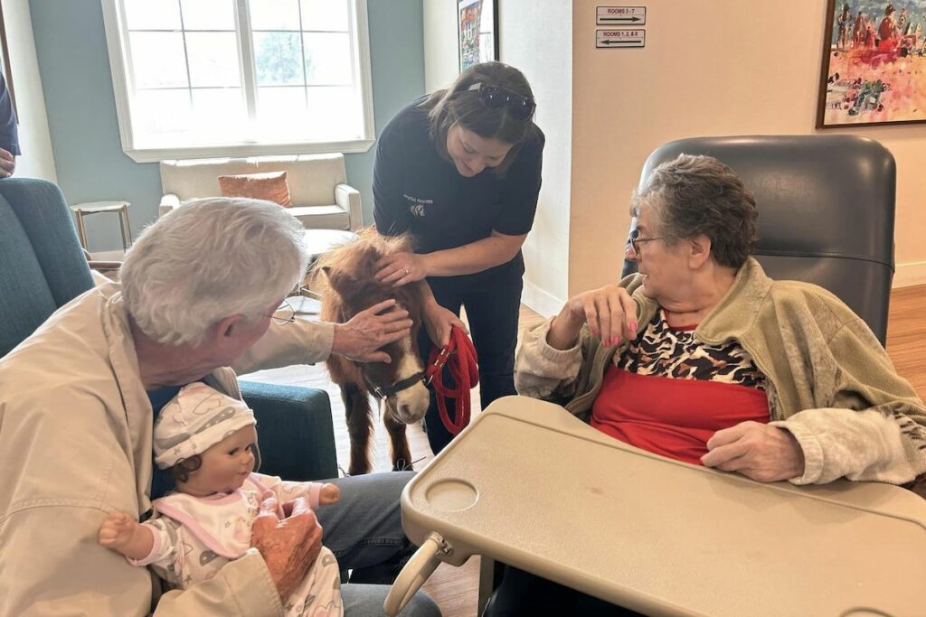 Sage Oak of Denton | Senior residents petting a dog