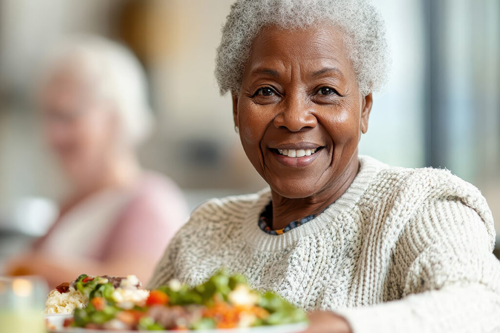 Sage Oak of Denton | Happy Senior Woman Eating A Healthy Meal