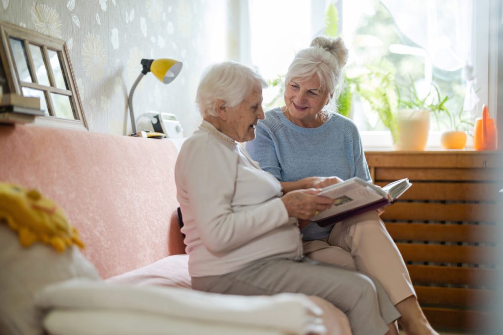 adult child helping aging mom read