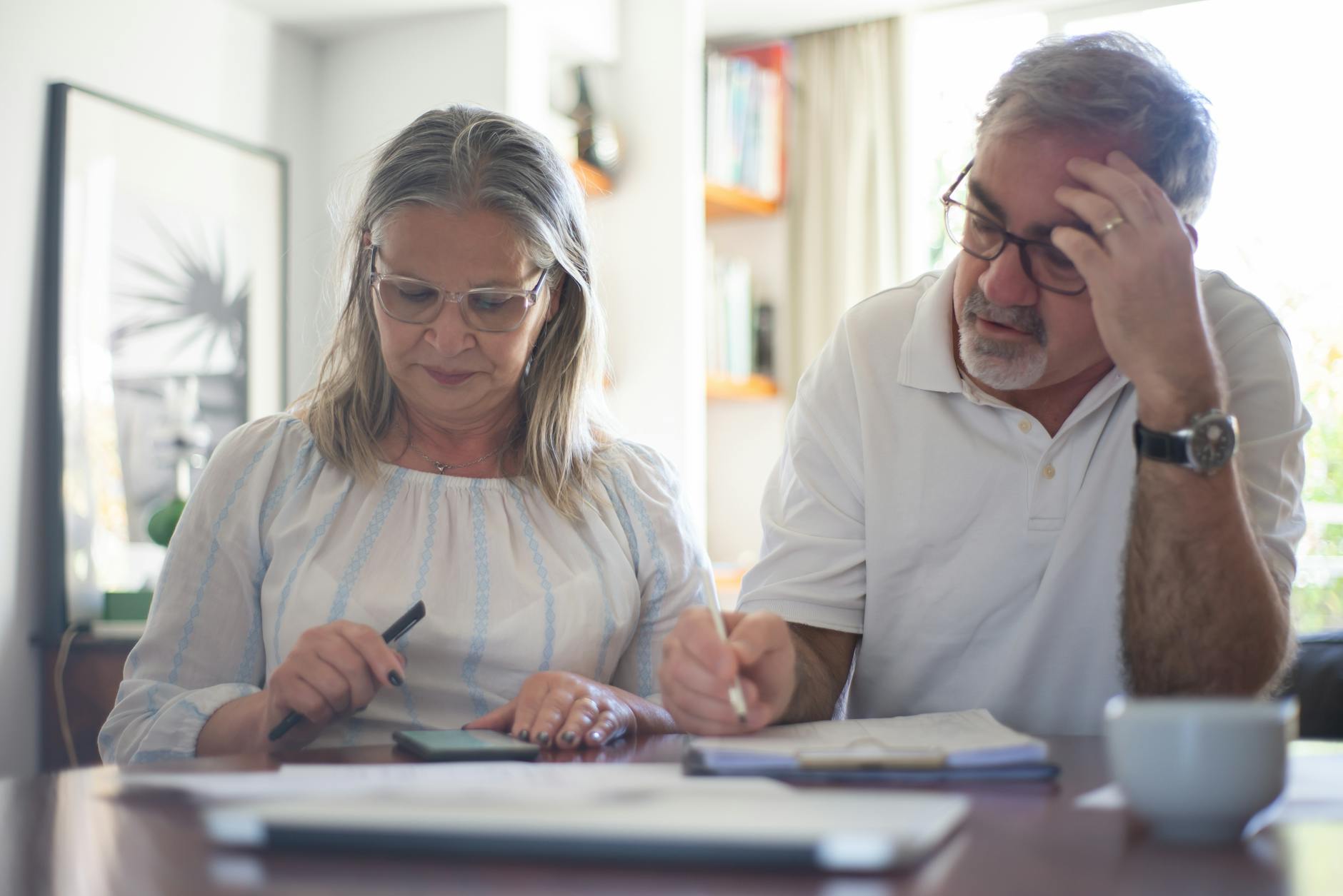 elderly couple making notes