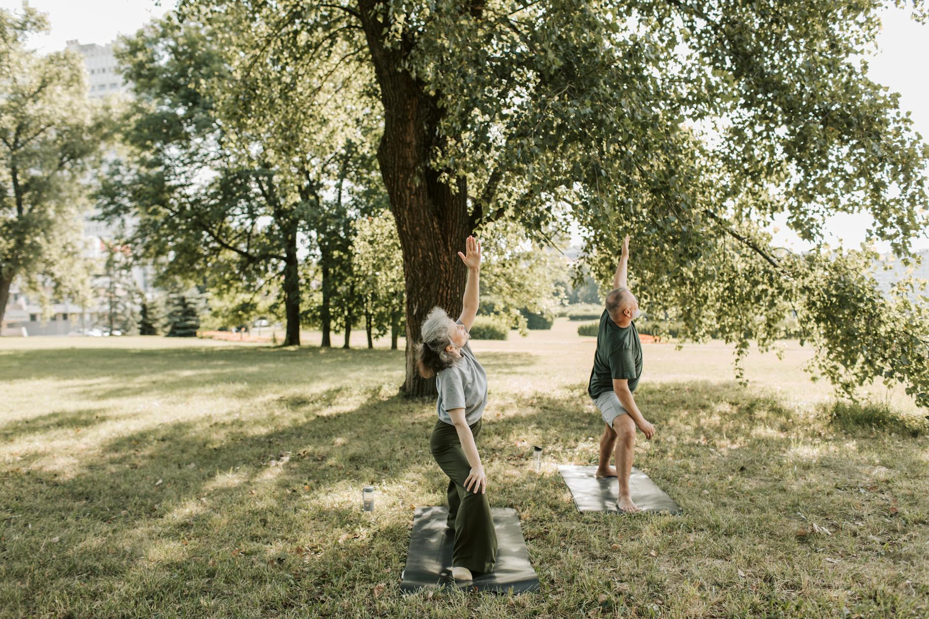 man and woman doing yoga outdoors