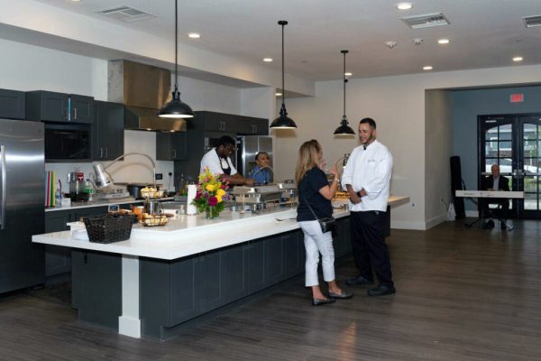 Sage Oak of Denton | Guest socializing with chef at grand opening