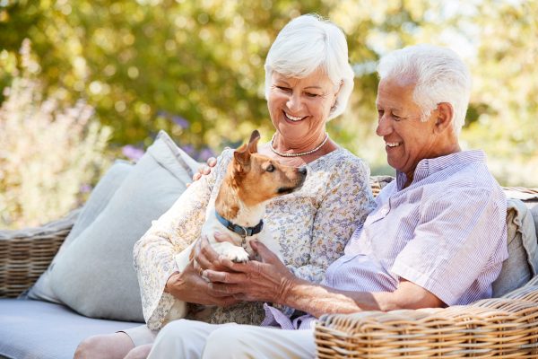 Sage Oak of Denton | Senior couple sitting outside with their dog